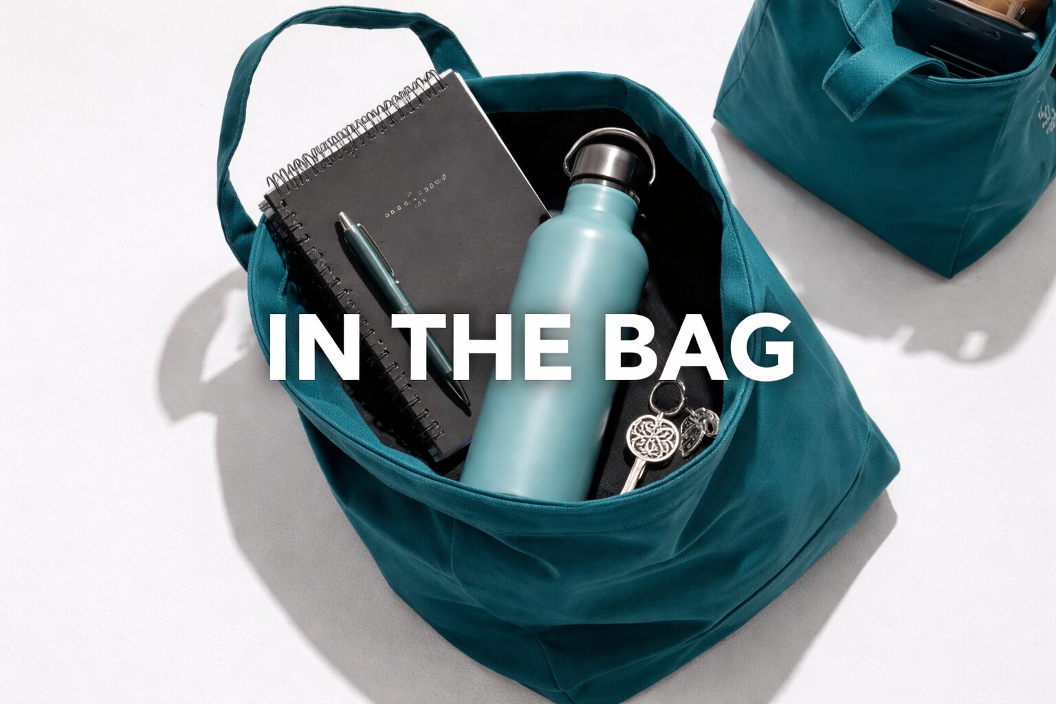 A teal bag with a water bottle and notebook inside, labeled 'IN THE BAG'.