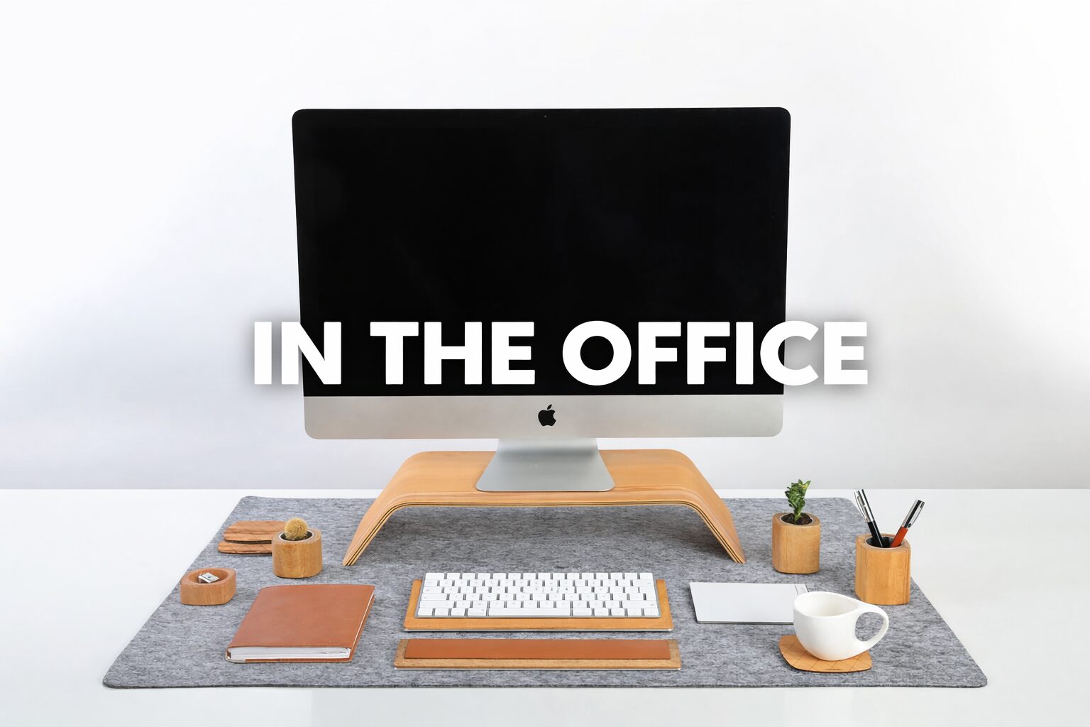 A stylish office desk setup with a computer and organized accessories.