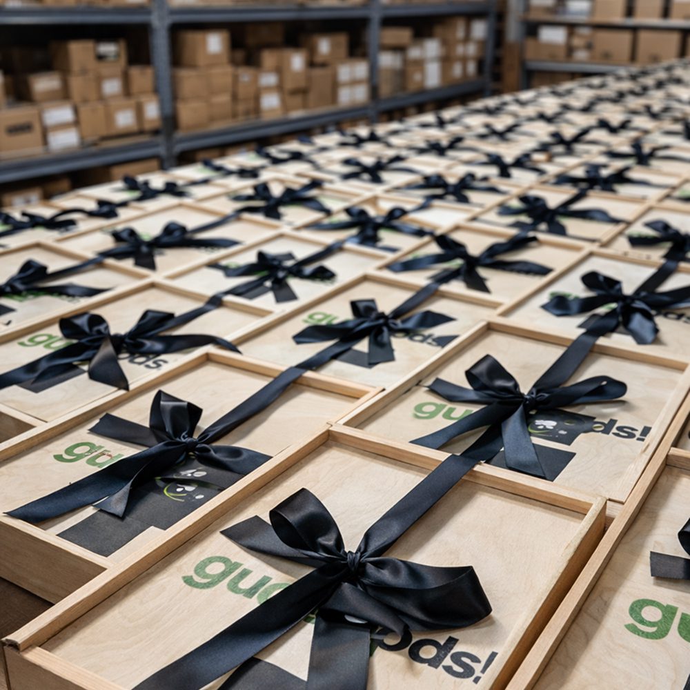 Neatly arranged gift boxes with black ribbons on a table.
